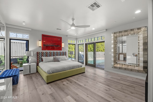 bedroom featuring light hardwood / wood-style flooring, multiple windows, and ceiling fan