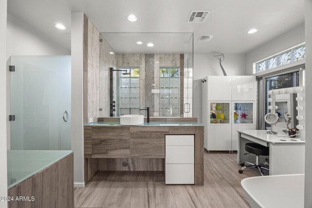 bathroom featuring hardwood / wood-style floors, vanity, and independent shower and bath