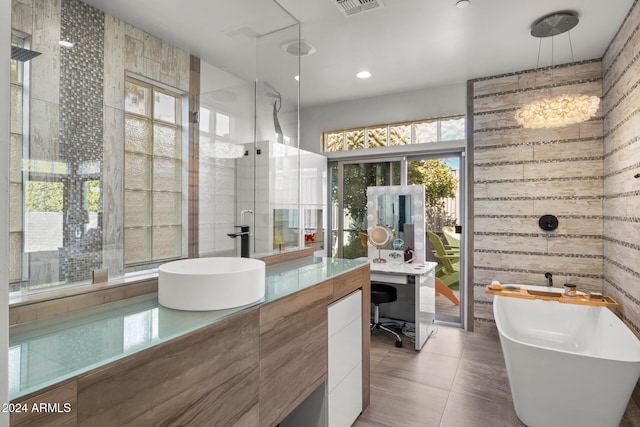 bathroom featuring tile patterned floors, vanity, shower with separate bathtub, and a wealth of natural light