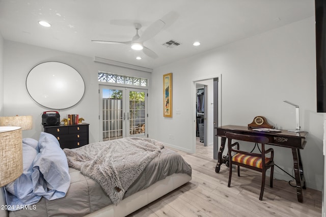 bedroom featuring french doors, light wood-type flooring, ceiling fan, a spacious closet, and a closet