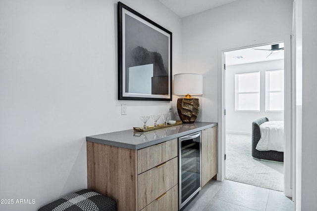 corridor with wine cooler and light tile patterned flooring