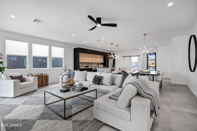 living room with ceiling fan with notable chandelier