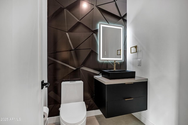 bathroom featuring toilet and vanity