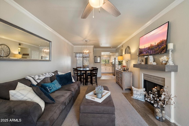 750 E Northern Ave Unit 2143, Phoenix, AZ 85020 - living room featuring a chandelier, ornamental molding, a fireplace with flush hearth, a ceiling fan, and wood finished floors