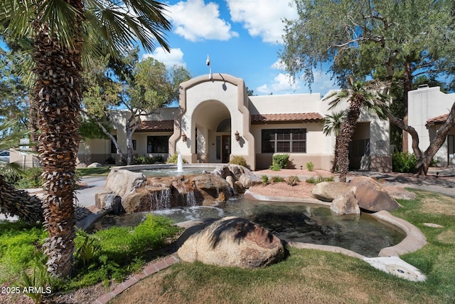 750 E Northern Ave Unit 2143, Phoenix, AZ 85020 - view of front facade featuring stucco siding, a small pond, and a tile roof