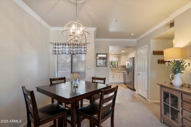 750 E Northern Ave Unit 2143, Phoenix, AZ 85020 - dining room with a chandelier, crown molding, baseboards, and light carpet