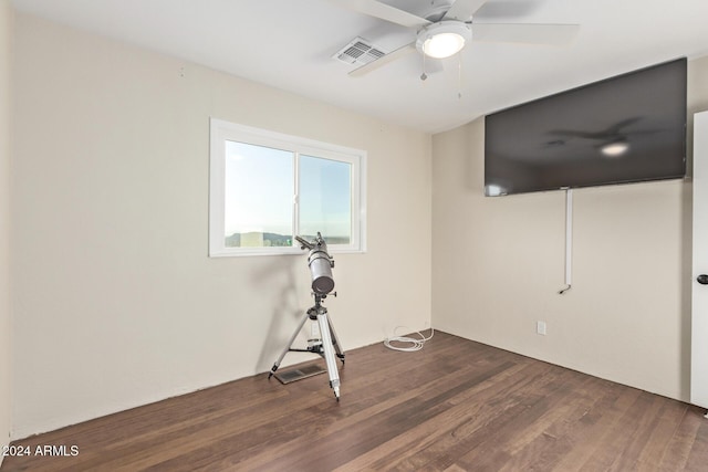 unfurnished room featuring dark hardwood / wood-style floors and ceiling fan