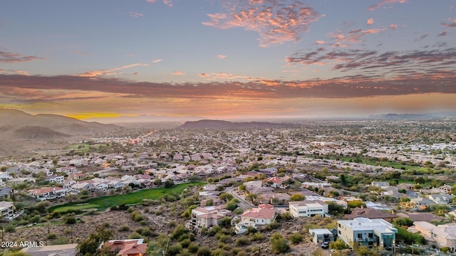 aerial view at dusk featuring a mountain view