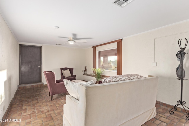 living room with ceiling fan and crown molding