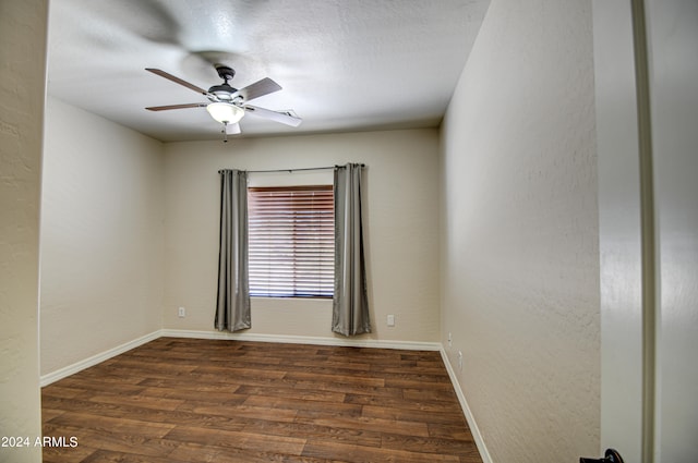 unfurnished room featuring ceiling fan and dark hardwood / wood-style flooring