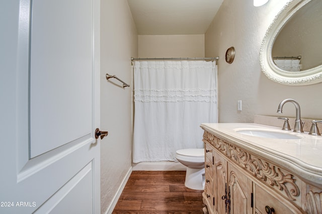 bathroom featuring toilet, hardwood / wood-style floors, vanity, and a shower with shower curtain