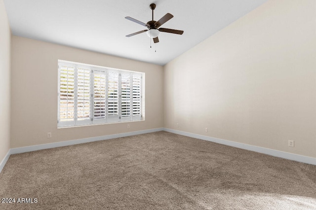 empty room with light carpet, ceiling fan, and vaulted ceiling