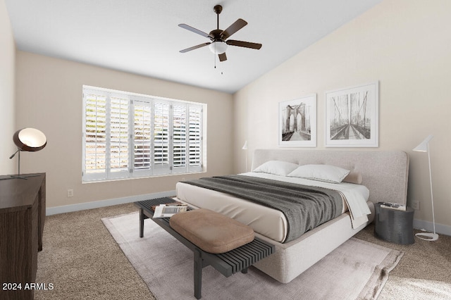 carpeted bedroom with ceiling fan and lofted ceiling