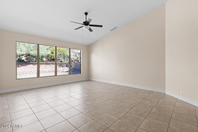 tiled spare room featuring ceiling fan and vaulted ceiling