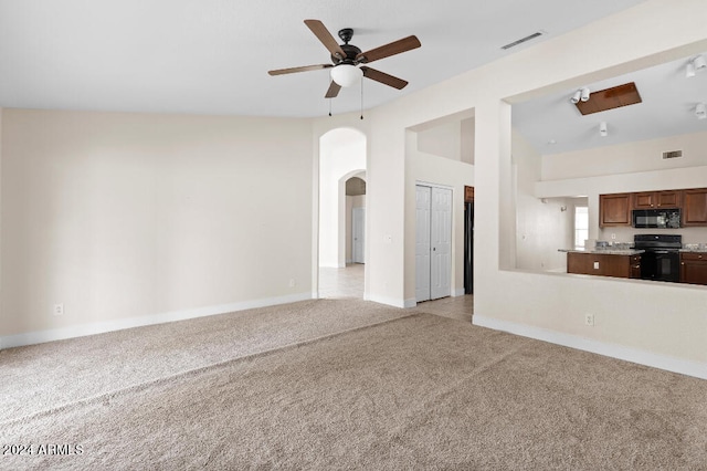 unfurnished living room featuring light carpet, lofted ceiling, and ceiling fan