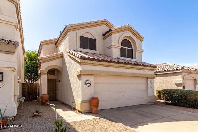 mediterranean / spanish home with driveway, a tiled roof, an attached garage, and stucco siding