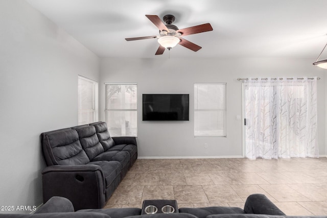 living room featuring ceiling fan and baseboards