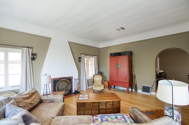 514 W Monte Vista Rd, Phoenix, AZ 85003 - living room with arched walkways, wood finished floors, baseboards, and a fireplace