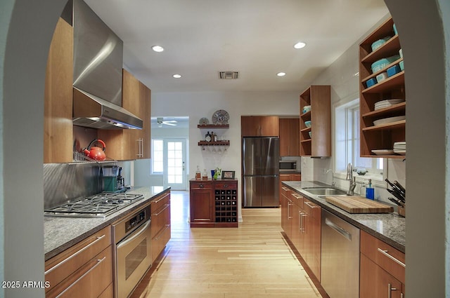 514 W Monte Vista Rd, Phoenix, AZ 85003 - kitchen with open shelves, appliances with stainless steel finishes, wall chimney range hood, light wood-style flooring, and ceiling fan