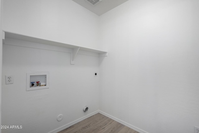 laundry area featuring washer hookup, light wood finished floors, gas dryer hookup, laundry area, and baseboards