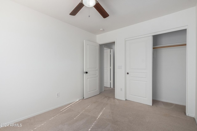 unfurnished bedroom with light carpet, ceiling fan, baseboards, and a closet