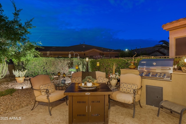 4200 E Narrowleaf Dr, Gilbert, AZ 85298 - patio at night with an outdoor kitchen, a grill, and fence