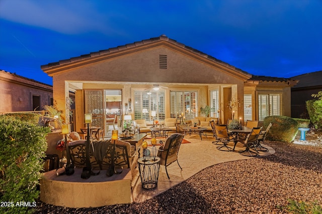 4200 E Narrowleaf Dr, Gilbert, AZ 85298 - back of house at twilight with an outdoor living space, a patio area, french doors, and stucco siding