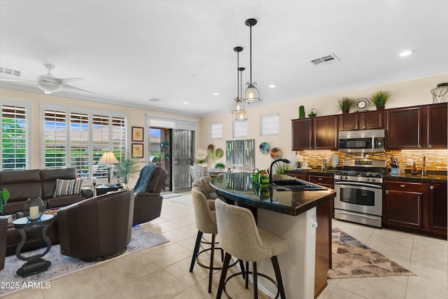 4200 E Narrowleaf Dr, Gilbert, AZ 85298 - kitchen featuring stainless steel appliances, dark countertops, visible vents, a sink, and open floor plan