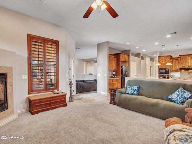 2724 W Fernwood Dr, Phoenix, AZ 85086 - living area with a tiled fireplace, baseboards, a ceiling fan, and visible vents