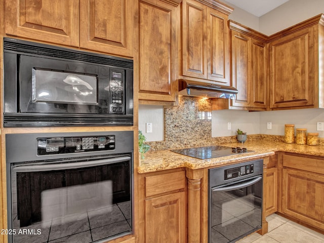 2724 W Fernwood Dr, Phoenix, AZ 85086 - kitchen featuring light tile patterned floors, light stone countertops, black appliances, under cabinet range hood, and brown cabinets
