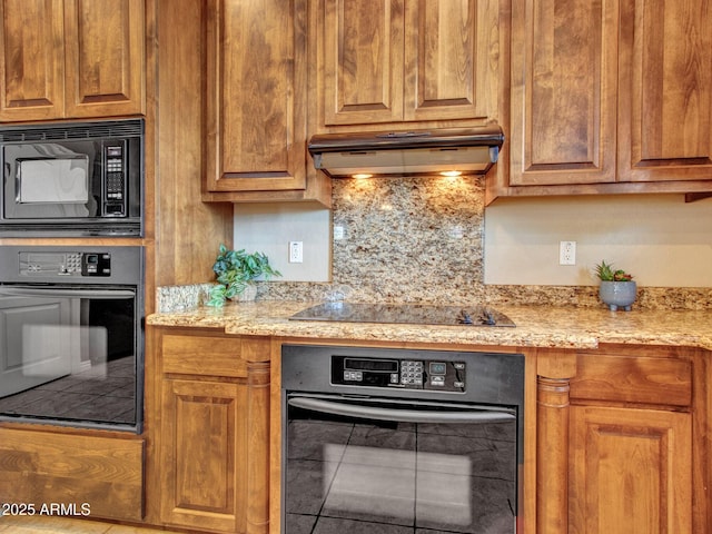 2724 W Fernwood Dr, Phoenix, AZ 85086 - kitchen featuring ventilation hood, black appliances, light stone counters, brown cabinets, and backsplash