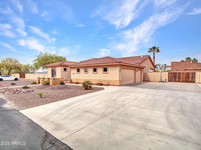 2724 W Fernwood Dr, Phoenix, AZ 85086 - mediterranean / spanish-style house featuring stucco siding, driveway, an attached garage, a tile roof, and fence