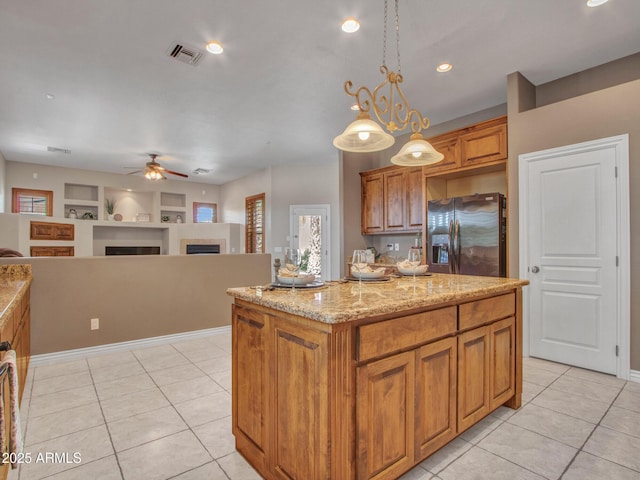 2724 W Fernwood Dr, Phoenix, AZ 85086 - kitchen featuring stainless steel refrigerator with ice dispenser, a ceiling fan, a fireplace, brown cabinets, and light tile patterned flooring