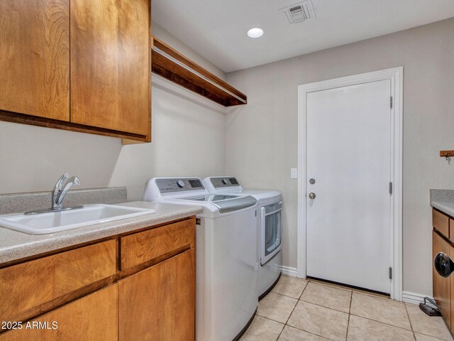 2724 W Fernwood Dr, Phoenix, AZ 85086 - laundry area featuring light tile patterned floors, visible vents, a sink, cabinet space, and washing machine and clothes dryer