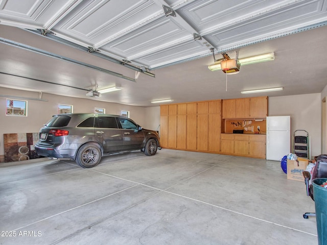 2724 W Fernwood Dr, Phoenix, AZ 85086 - garage featuring freestanding refrigerator and a garage door opener