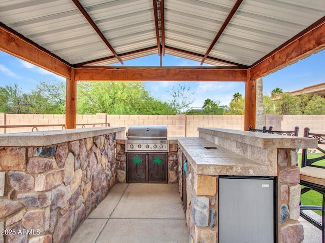 2724 W Fernwood Dr, Phoenix, AZ 85086 - view of patio featuring a grill, a gazebo, a fenced backyard, and an outdoor kitchen