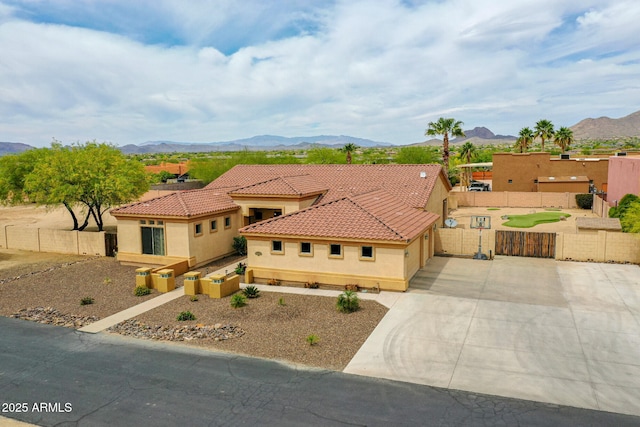 2724 W Fernwood Dr, Phoenix, AZ 85086 - mediterranean / spanish house featuring a mountain view, a tile roof, fence, concrete driveway, and stucco siding