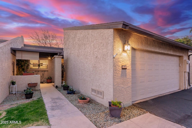 property exterior at dusk with a garage