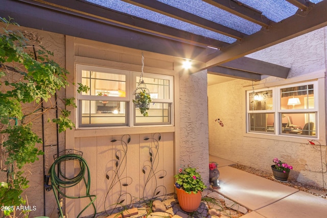 doorway to property featuring a pergola