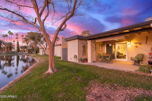 yard at dusk with a patio