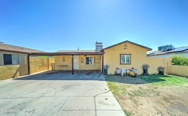 6541 N 54th Ave, Glendale, AZ 85301 - rear view of house with stucco siding, a carport, and concrete driveway
