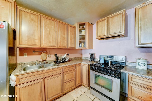 6541 N 54th Ave, Glendale, AZ 85301 - kitchen featuring stainless steel appliances, a sink, light brown cabinetry, light countertops, and a textured ceiling