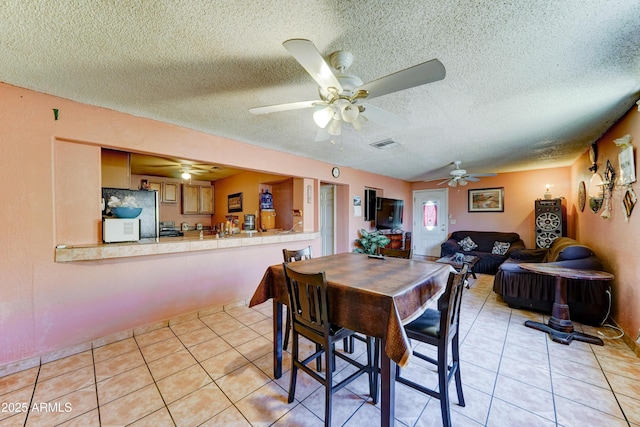 6541 N 54th Ave, Glendale, AZ 85301 - dining space with light tile patterned flooring, a textured ceiling, and a ceiling fan
