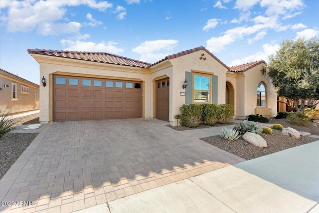 mediterranean / spanish-style home featuring a garage