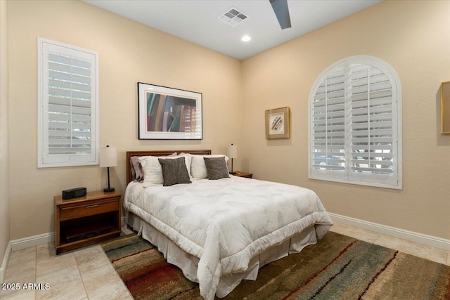 bedroom with ceiling fan and light tile patterned floors