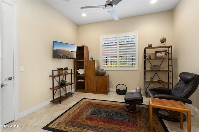 living area featuring ceiling fan and light tile patterned floors