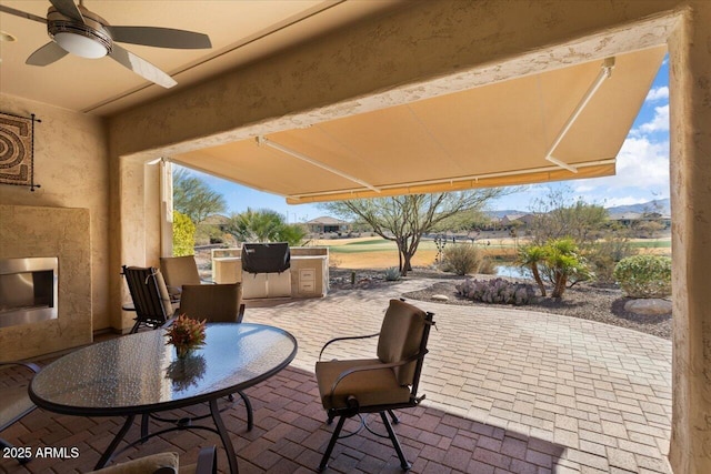 view of patio with ceiling fan and exterior kitchen