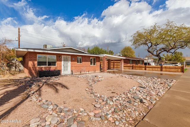 ranch-style home with brick siding and fence