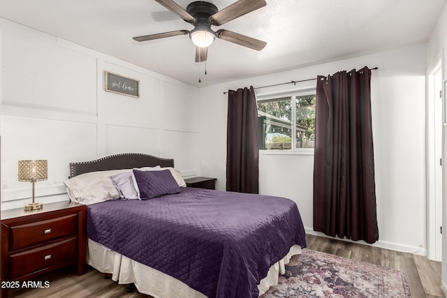 bedroom with a ceiling fan and wood finished floors