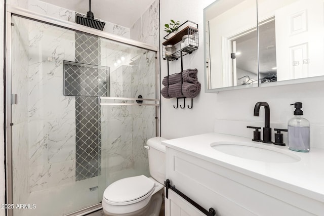 full bath with vanity, toilet, and a marble finish shower